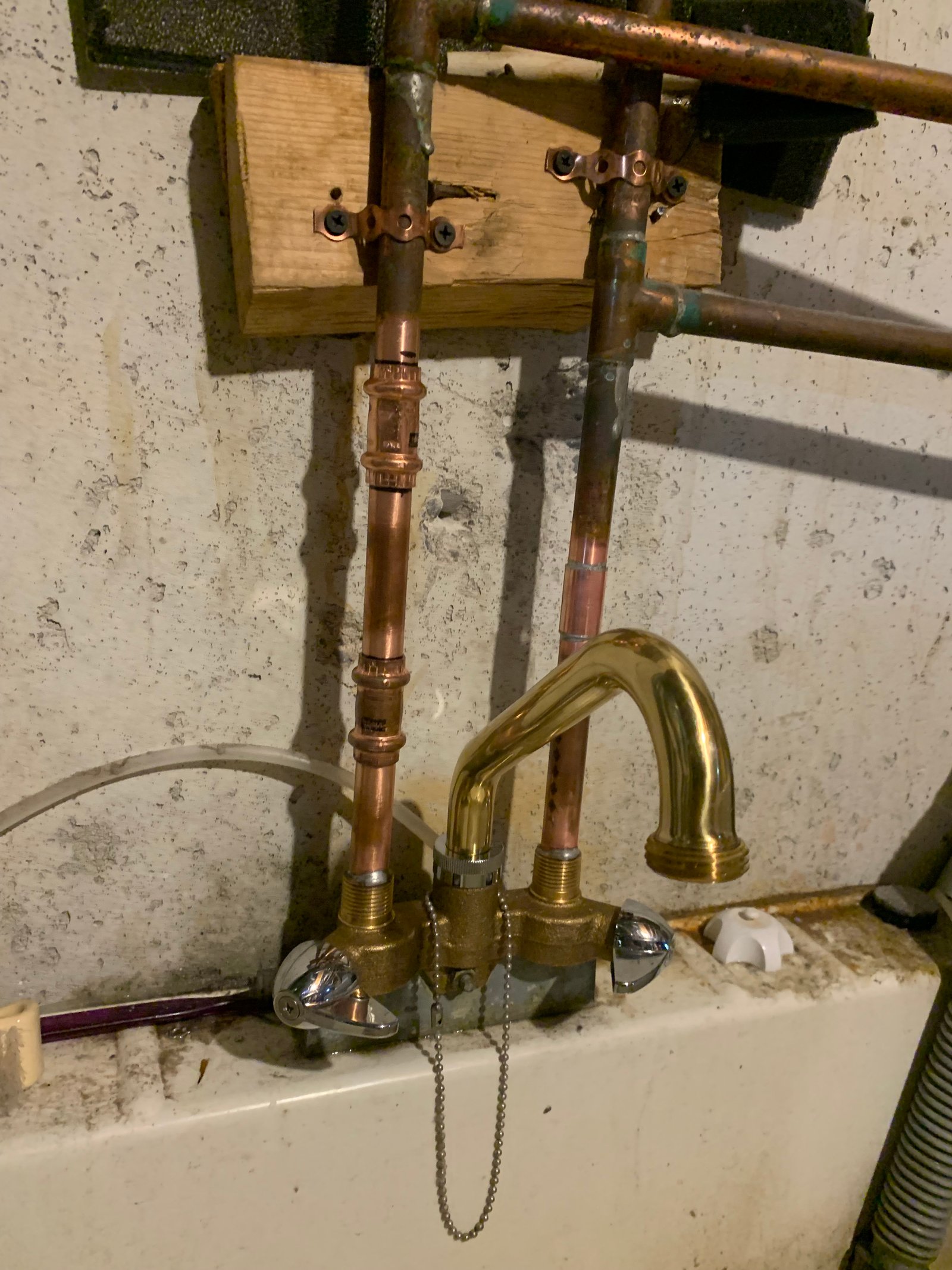 Brass water hammer arrestor valve fitting connected to supply lines to eliminate pipe banging noise